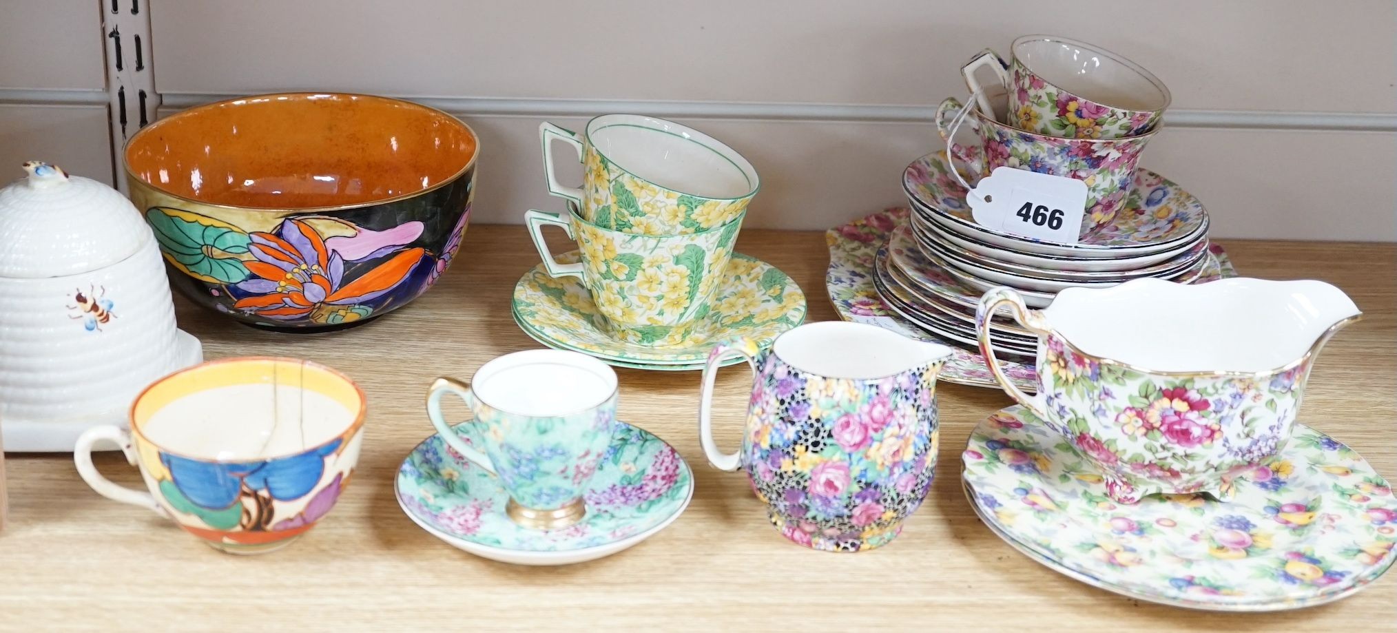 A Clarice Cliff tea cup, a collection of chintz patterned teaware, a lustre bowl and a honey pot and cover